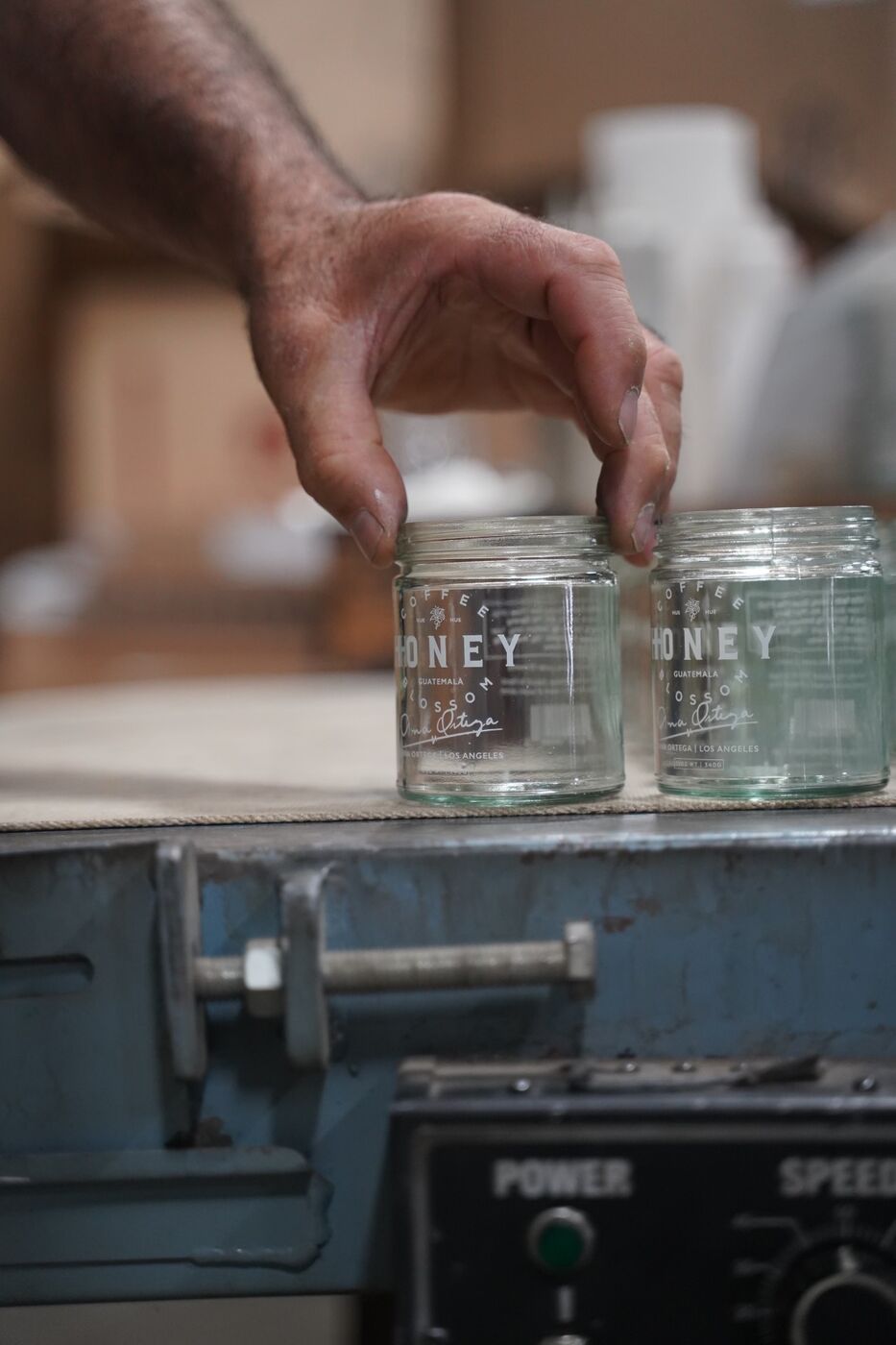 Lineup of custom screen-printed glass bottles and amber jars